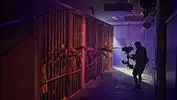 <i>A camera operator films actors inside the jail set. Courtesy of Ideal Sets.</i>